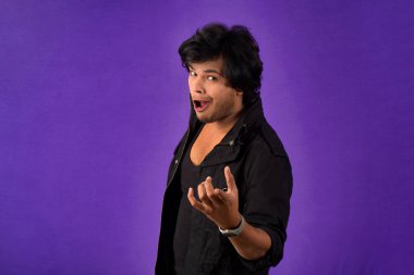 Young handsome man over dark background afraid and shocked with surprise and amazed expression, fear and excited face.