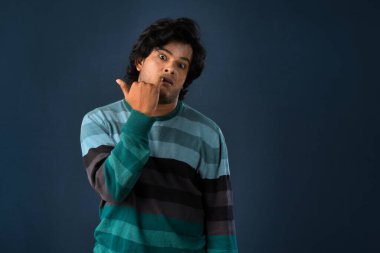 Portrait of a young man thinking on a dark background
