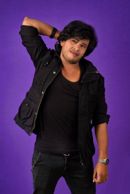 Portrait of a young man thinking on a dark background