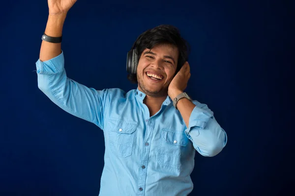Portrait Handsome Young Man Enjoying Music Headphones Blue Background — Stockfoto