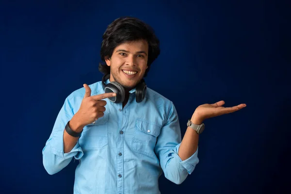 Portrait Handsome Young Man Enjoying Music Headphones Blue Background — Stockfoto