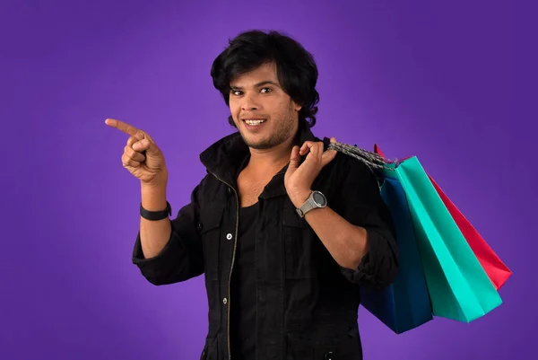 Beautiful Indian Young Handsome Man Holding Posing Shopping Bags Purple — Stockfoto