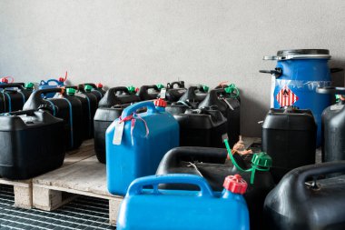 Metal and plastic barrels containing hazardous chemicals from industry, waste management concept, industrial background