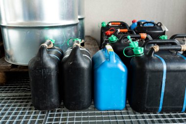 Metal and plastic barrels containing hazardous chemicals from industry, waste management concept, industrial background