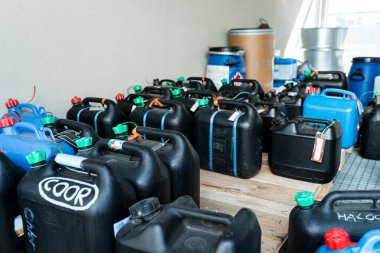 Metal and plastic barrels containing hazardous chemicals from industry, waste management concept, industrial background