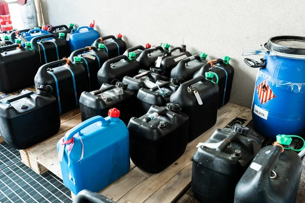 Metal and plastic barrels containing hazardous chemicals from industry, waste management concept, industrial background