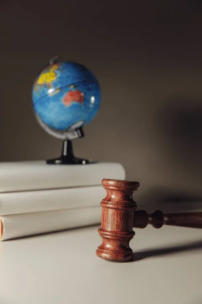 Wooden Judge gavel and globe. International environment law concept. Vertical image — Stock Photo, Image