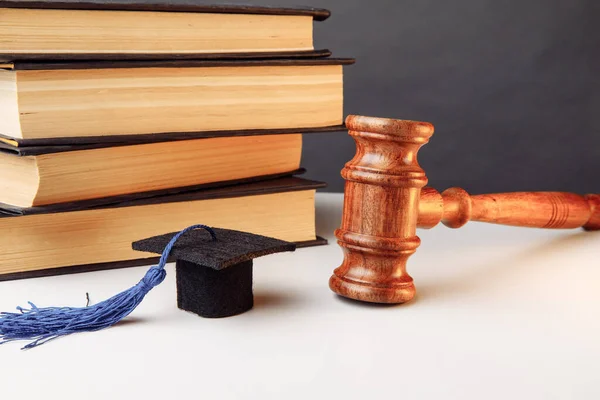 Law or education concept. Books with graduation cap and wooden gavel — Stock Photo, Image