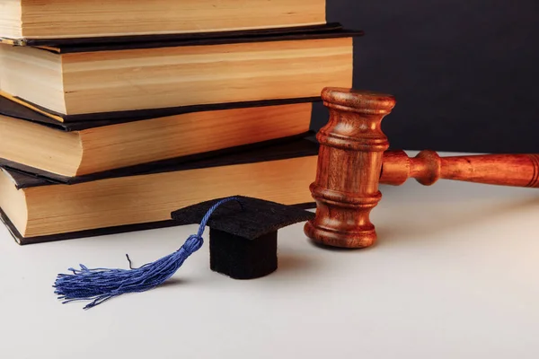 Stack of books, academic cap and gavel on the table — Stock Photo, Image