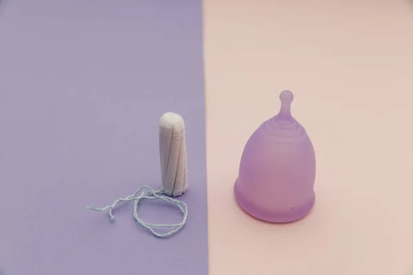 Menstruatiecup en tampons op een kleurrijke achtergrond. Concept van de gezondheid van vrouwen — Stockfoto