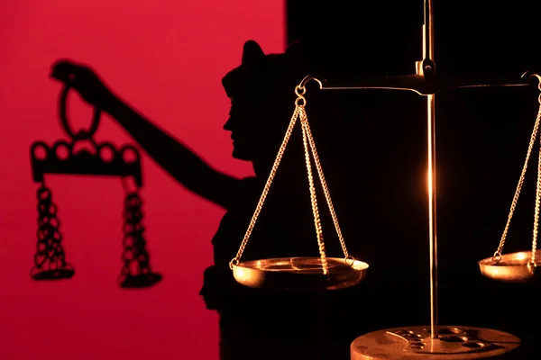 Legal law concept image Scales of Justice and case books on desk.