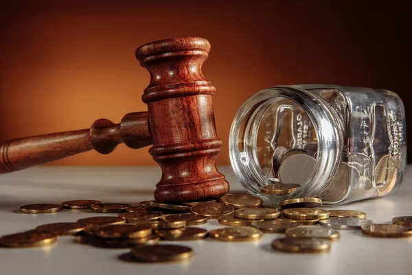 Glass jar with coins and wooden gavel. Judgement concept — Stock Photo, Image