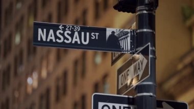 Nassau Street and One Way Sign in Manhattan at Night. Street Signs on Black Pole. Directions and Destination in New York City