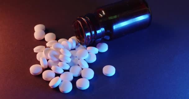 瓶の中の鎮痛剤暗い背景の白い錠剤 ガラス容器内の薬物及び違法物質 — ストック動画