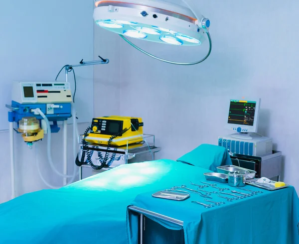 white operating room with light shine on bed and medical equipment, operation or surgery room in hospital for doctor and patient