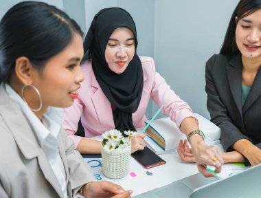 young islam women present online reports on laptop to colleague in office workplace and meeting room, professional business worker busy working in office