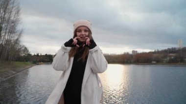  Kız elleriyle kalbini gösteriyor.