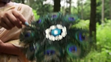 Puja. Kadın eli yelpaze tutuyor.