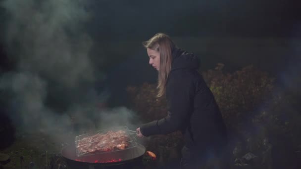 Fille frites un barbecue et ventilateur le feu — Video