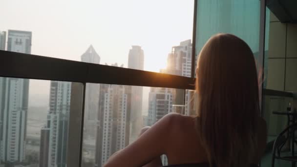 Girl sits on the balcony. High floor apartment — Video Stock