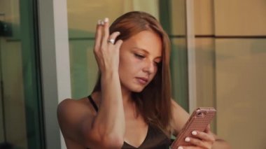  woman smokes a cigarette and Scrolls the screen