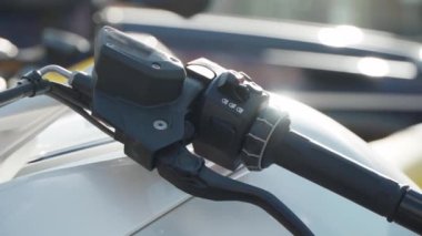 handle of a motorbike on the street in sunny weather