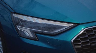 beautiful blue car with glowing headlights