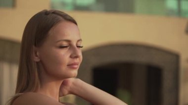 woman basking in the sun and smiling for the camera