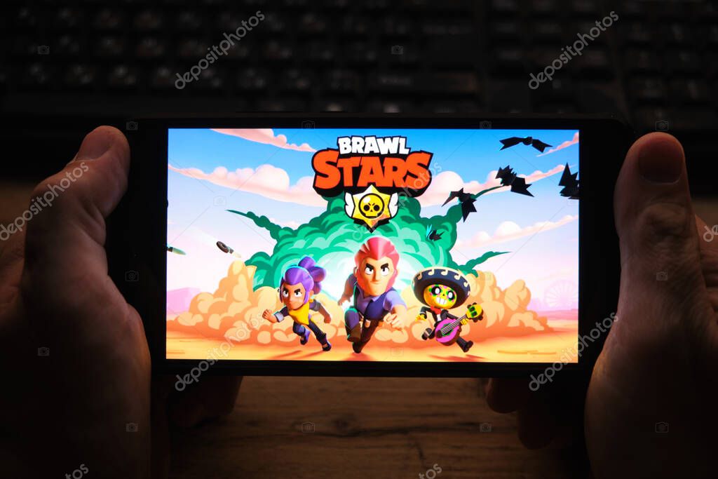 Kostanay, Kazakhstan, November 04, 2021.A man holds a mobile phone with a screensaver of the popular Brawl Stars game