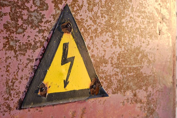 Old Rusty Warning Danger High Voltage Form Lightning Yellow Background — стоковое фото