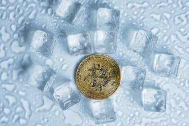 Bitcoin para orta eritme buz küpleri ve hafif arkaplan üzerine su damlaları