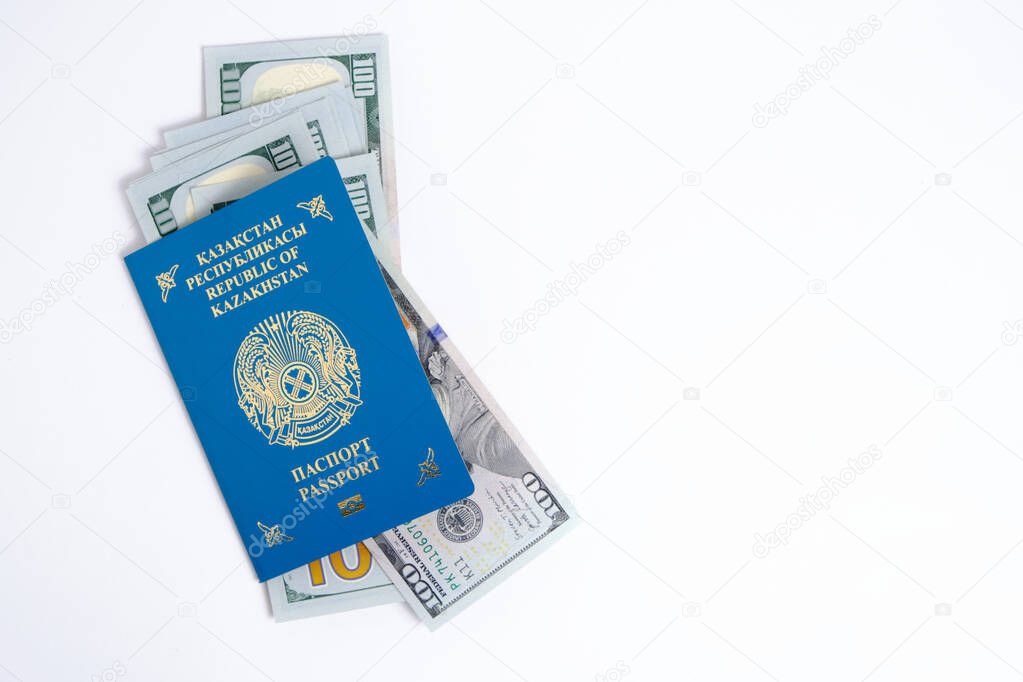Passport citizen Republic Kazakhstan blue with coat arms and pack hundred-dollar bills inside, on white background