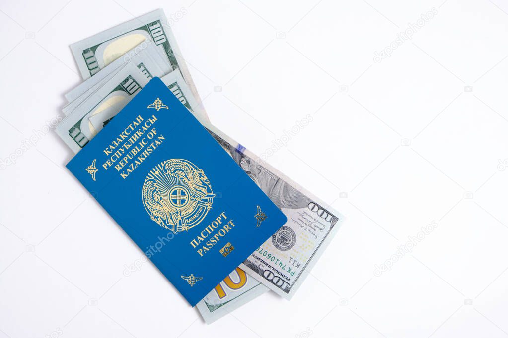 Passport citizen Republic Kazakhstan blue with coat arms and pack hundred-dollar bills inside, on white background