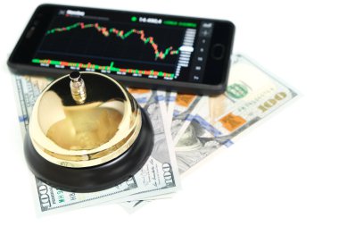 Akıllı telefon ekranı borsa çizelgesi, beyaz zemin üzerinde çan ve 100 dolarlık banknotlar. Konsept, hisse senedi, iş ve finans