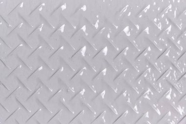 Arka plan, elmas şekilli metal dokusu, gri boyayla boyanmış.