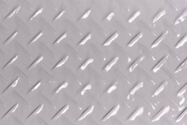 Arka plan, elmas şekilli metal dokusu, gri boyayla boyanmış.