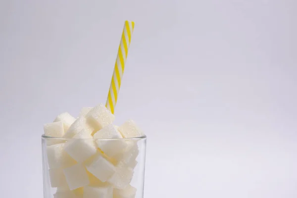 Glas Met Geraffineerde Suikerklontjes Een Drinkbuis Een Witte Ondergrond — Stockfoto