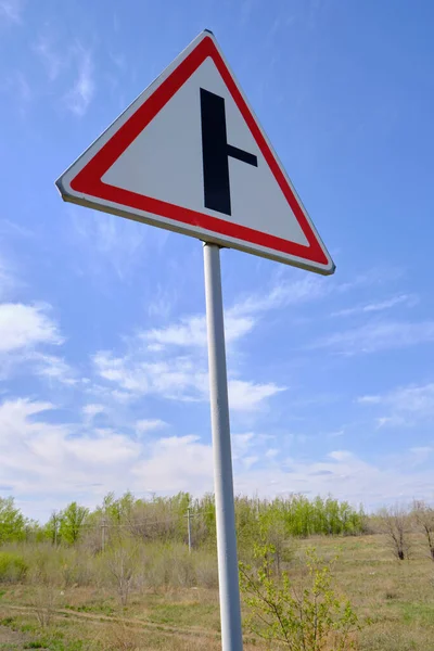 Road Sign Warning Turn Main Road Blue Sky Background — стоковое фото