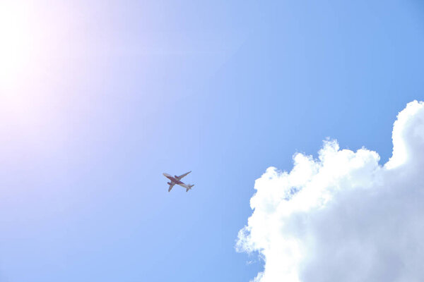 Plane takes gainst background blue sky and white clouds