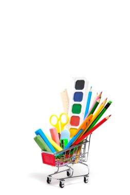 Okul gereçleri ve kırtasiye malzemesi alışveriş sepetinde beyaz arka plan. Çocuğu okul yılına hazırlıyorum.