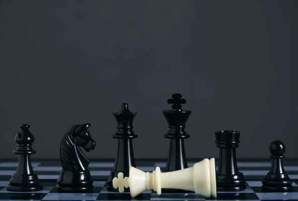 Standing Black Chess Pieces Lying White King — Stok fotoğraf