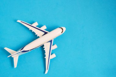 Airplane model blue background.Concept travel and recreation