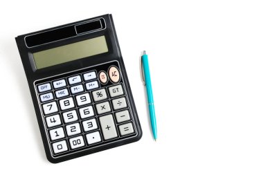 Calculator turned off and a ballpoint pen on white background