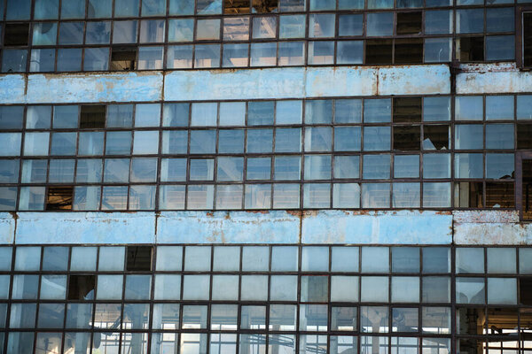 Broken glass facade old, industrial, abandoned factory building