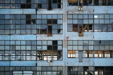 Broken glass facade old, industrial, abandoned factory building