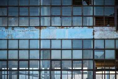 Broken glass facade old, industrial, abandoned factory building
