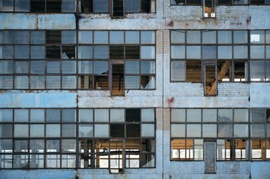Broken glass facade old, industrial, abandoned factory building