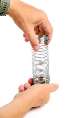 Metal spring antistress toy,slinky, in hand white background