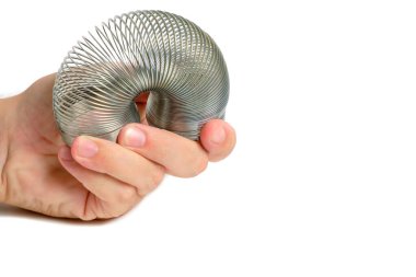 Metal spring antistress toy,slinky, in hand white background