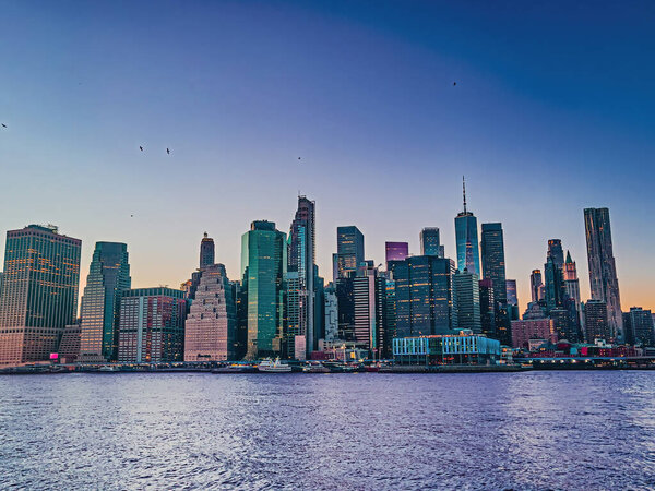 Panoramic view of Manhattan skyline taken from Brooklyn bridge park during set in New York City, NY